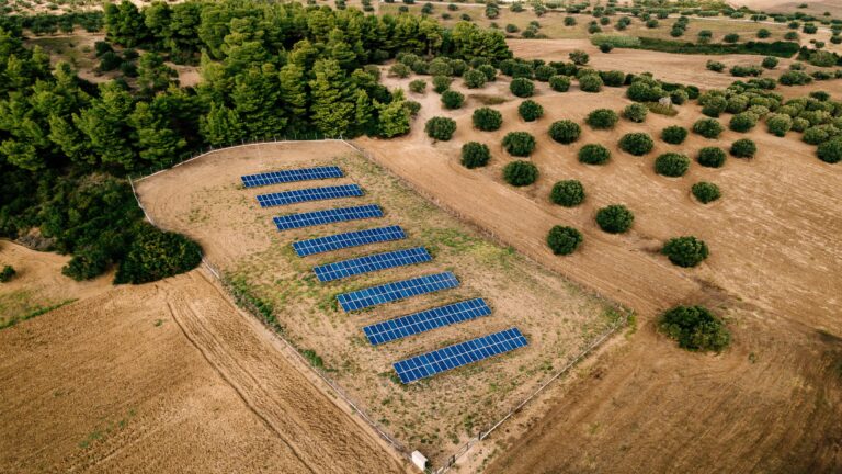 Aerial view of Solar panels farm in a field in the countryside in Greece. Drone photography